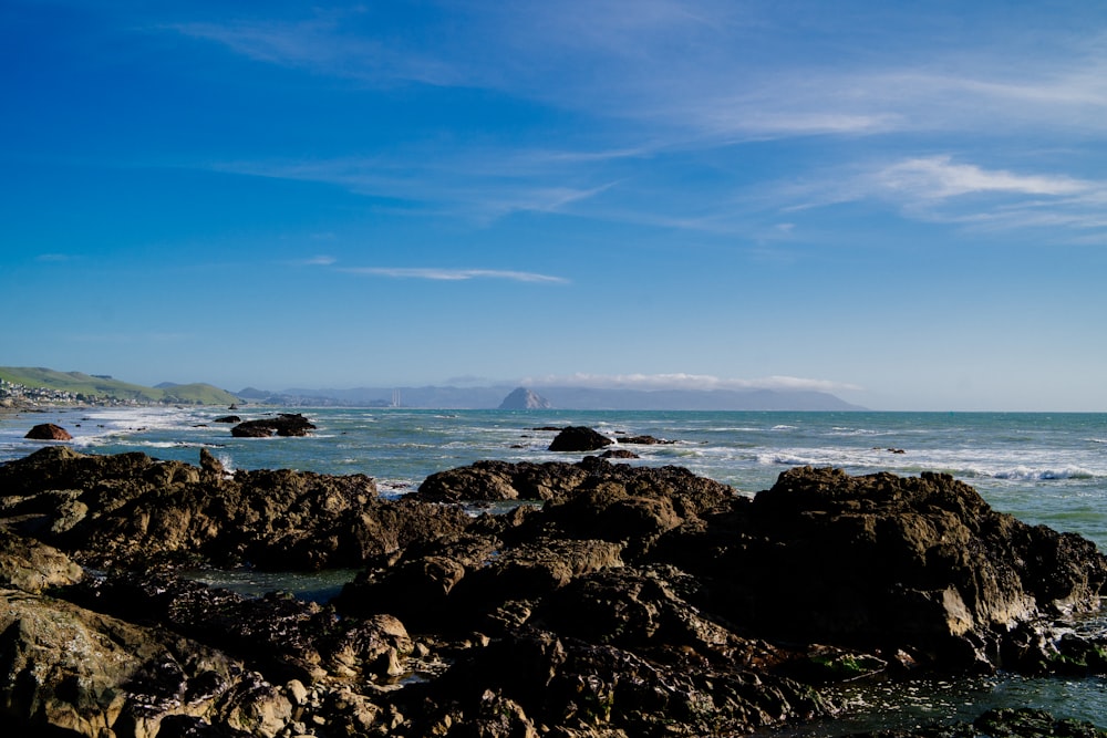 a view of the ocean from a rocky shore