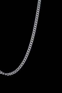 Stacked solid silver chains showcasing different link styles and thicknesses.