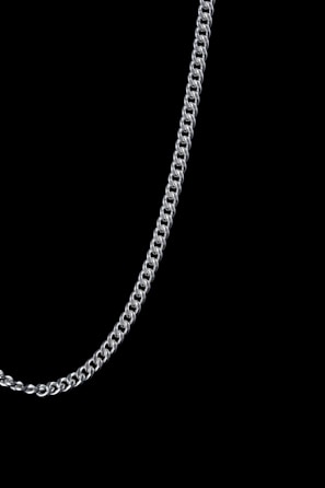 Close-up of a silver chain link glowing with a liquid metal sheen floating against pitch black background