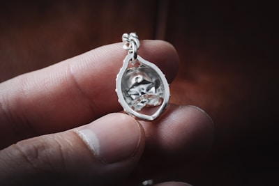 Close-up of a finely crafted custom eye pendant with delicate metalwork.