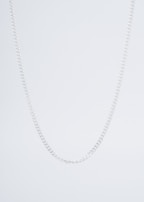 A model showcasing a statement necklace against a neutral background.