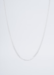 Minimalist silver chain necklace displayed on a white cracked marble background.