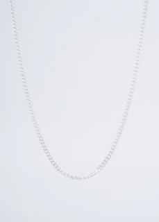 Men's silver chain necklace displayed on a rustic wooden table with natural light