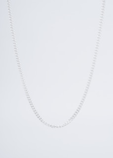 A model wearing a stylish gold chain necklace against a neutral background.