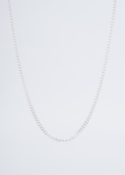 Minimalist silver chain necklace displayed on a white cracked marble background.
