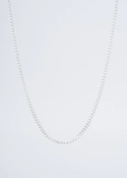 Modern silver necklace displayed on a clean white stand highlighting its sleek lines.