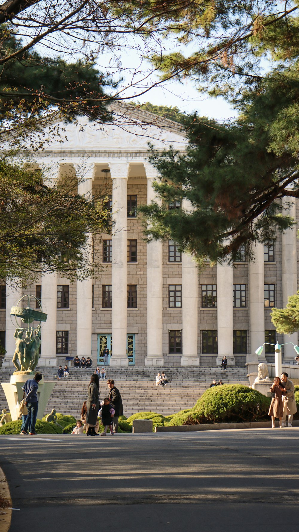 a group of people sitting on a bench in front of a building