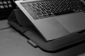 Close-up of a laptop screen showing a clean, professional SOP template in navy and slate grey.