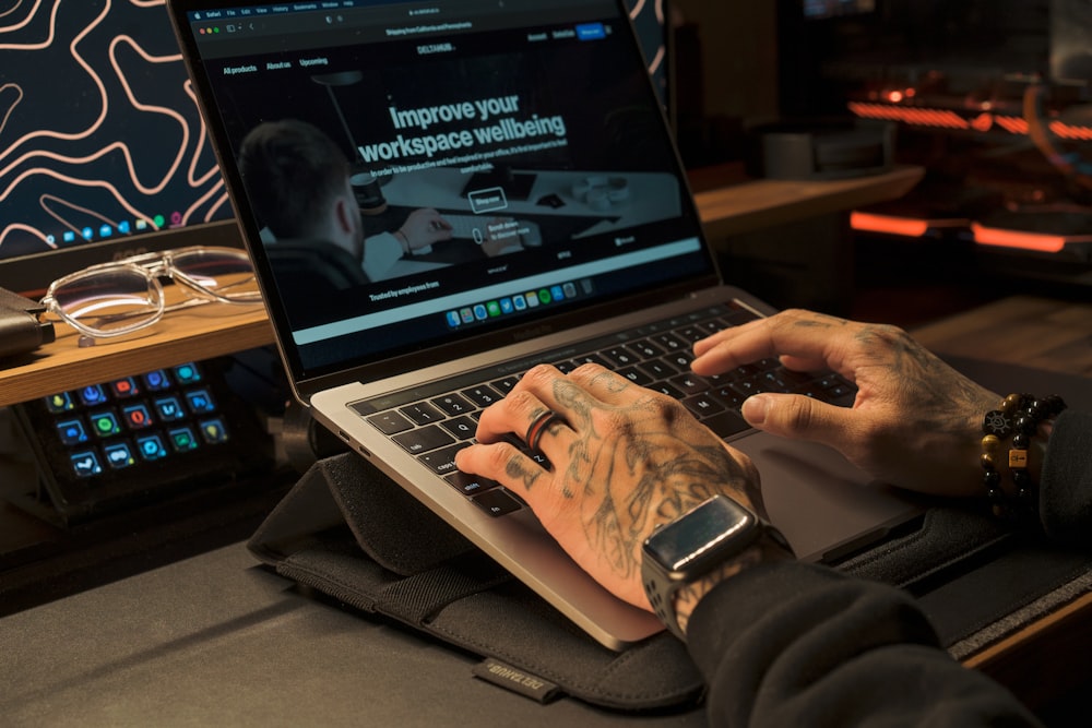 a man using a laptop computer on a desk