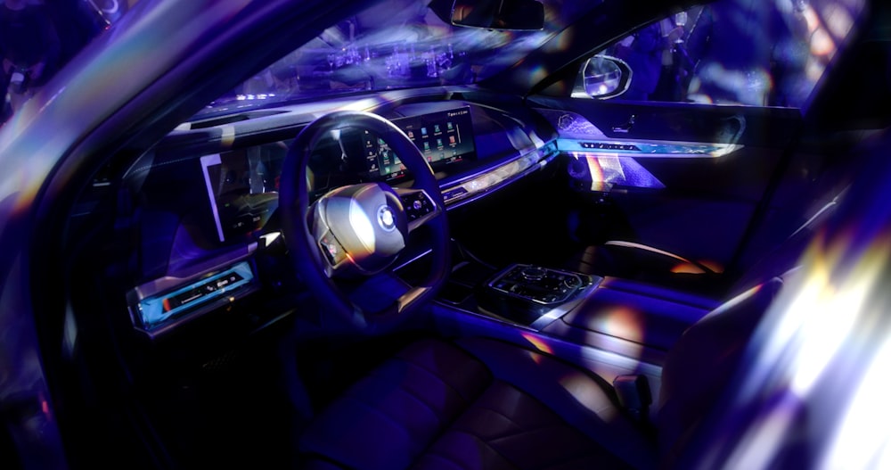 the interior of a car with blue lights