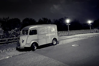 A clean, modern service van parked outside a classic San Francisco home at dusk.