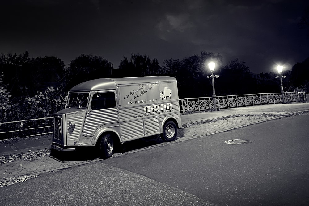 a van parked on the side of a road at night