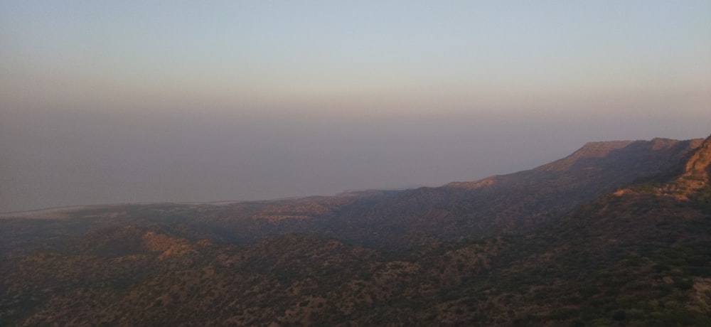 a view of a mountain range with a hazy sky