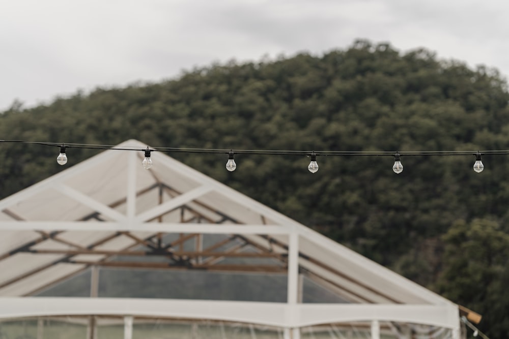 a white tent with string lights hanging from it