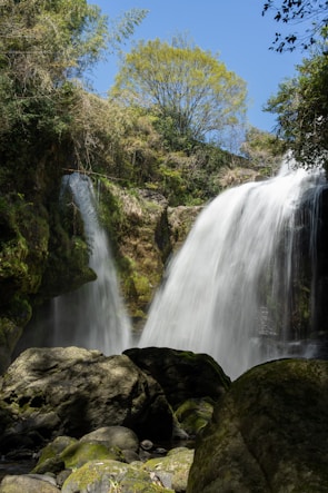 A picturesque waterfall cascading down rocky cliffs.
