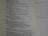 A close-up view of a page from a book or document with text printed on it. The text appears to be from a religious or philosophical book, possibly a Bible. Some handwritten notes are visible on the right side of the page, written on lined paper.