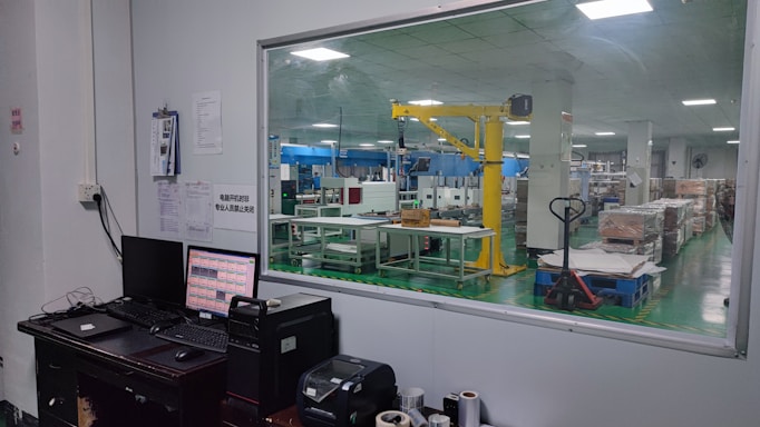 A dynamic photo of a factory floor with digital dashboards and automated machinery in action.