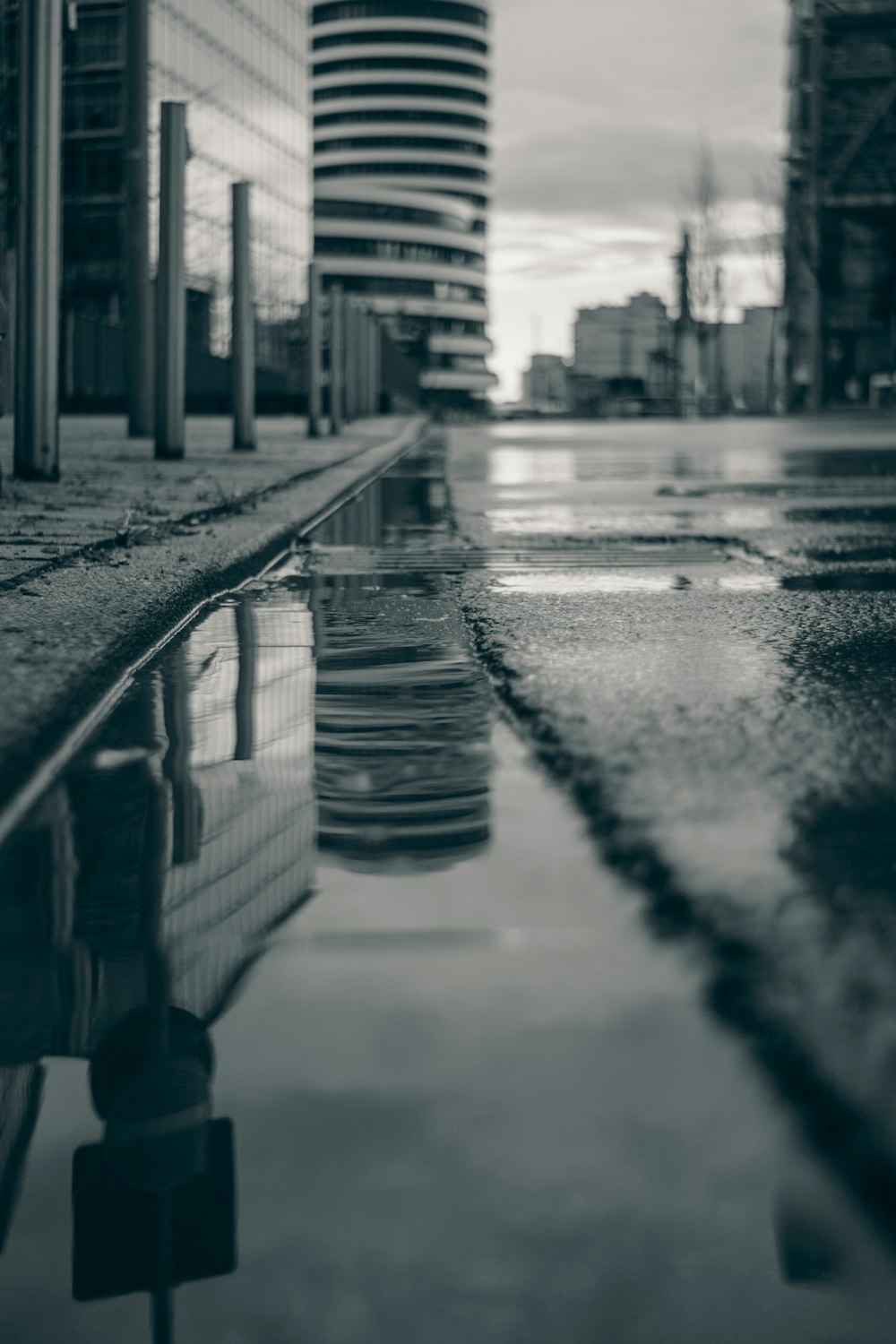 a city street with a puddle in the middle of it