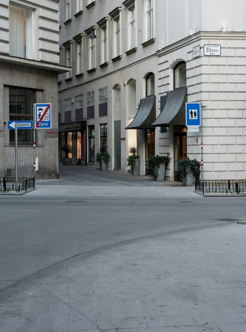 a street corner with a building in the background