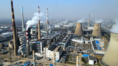 a factory with a lot of smoke coming out of it