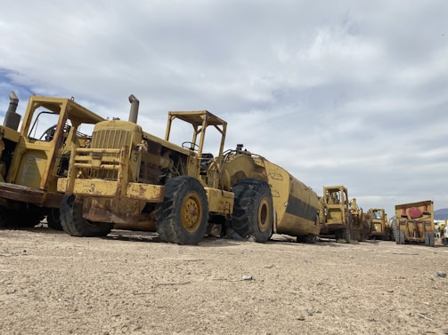 A row of construction machinery lined up ready for work at a commercial site.