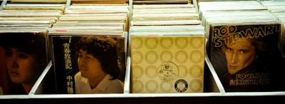 A collection of vinyl records displayed in an organized manner, showcasing album covers with diverse artwork. The central themes include music and classic record albums, offering a nostalgic glimpse into different musical eras.