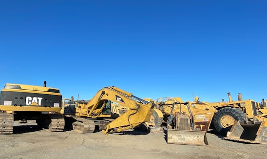 A diverse range of construction equipment displayed in an outdoor setting.