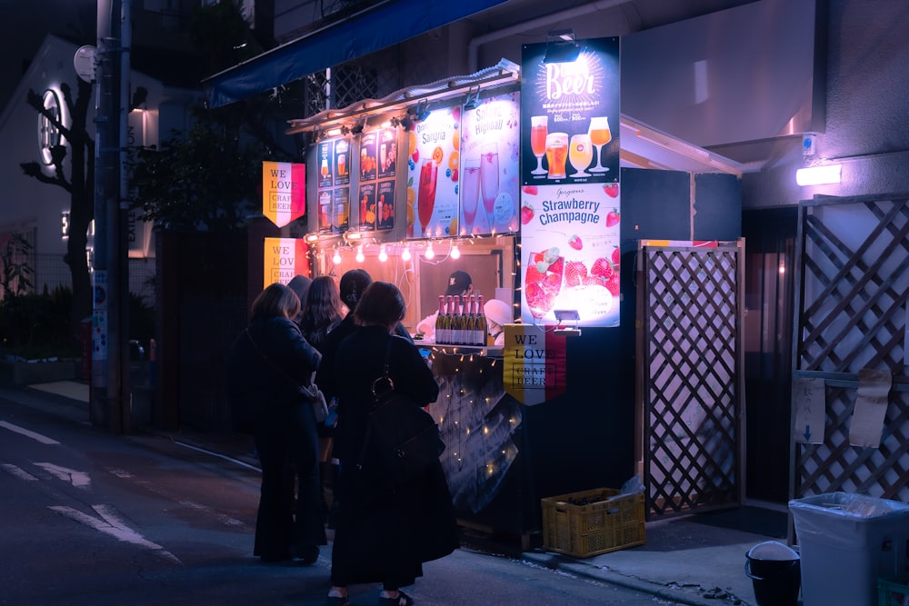 a group of people standing in front of a vending machine