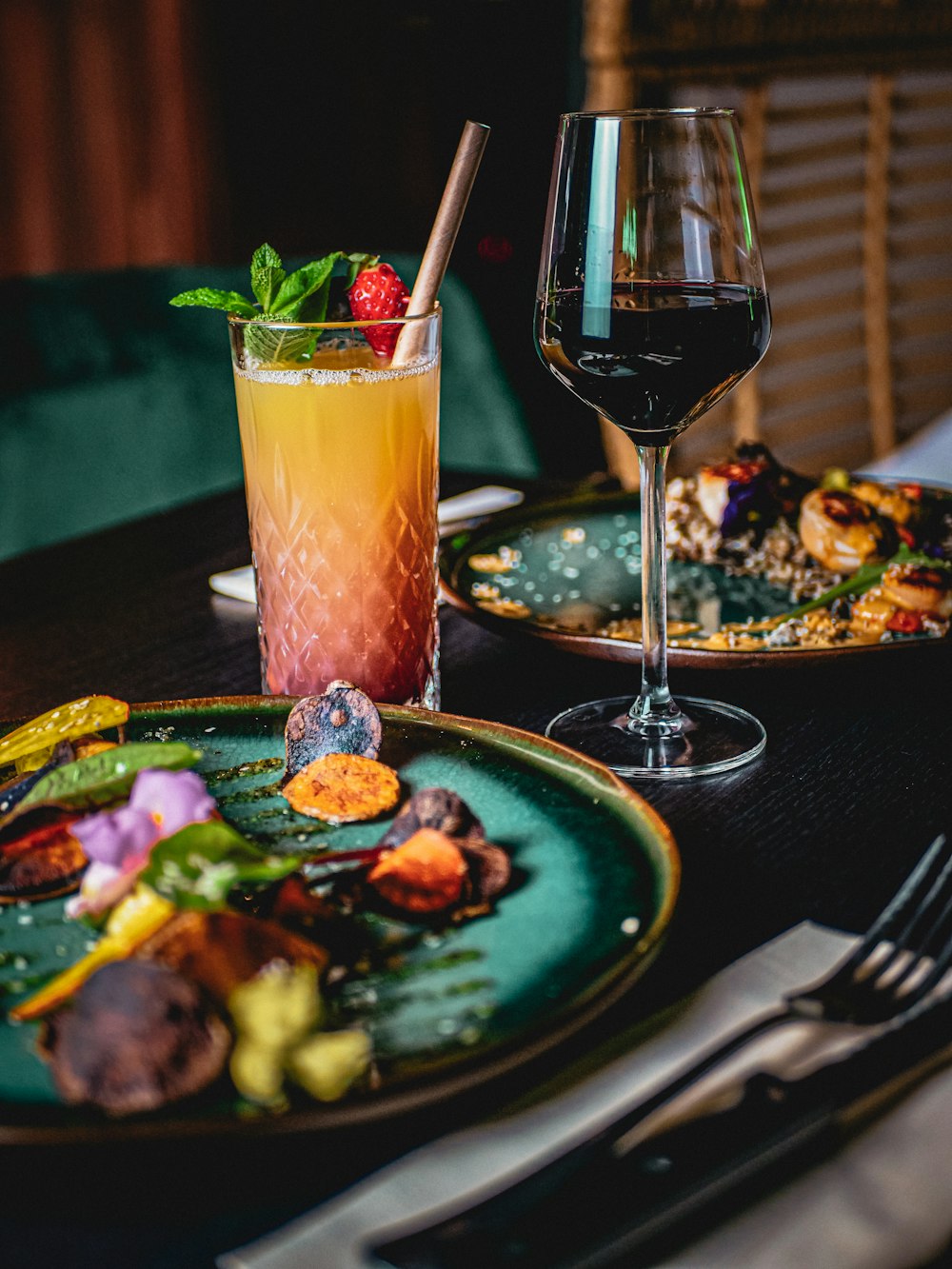 a plate of food and a glass of wine on a table