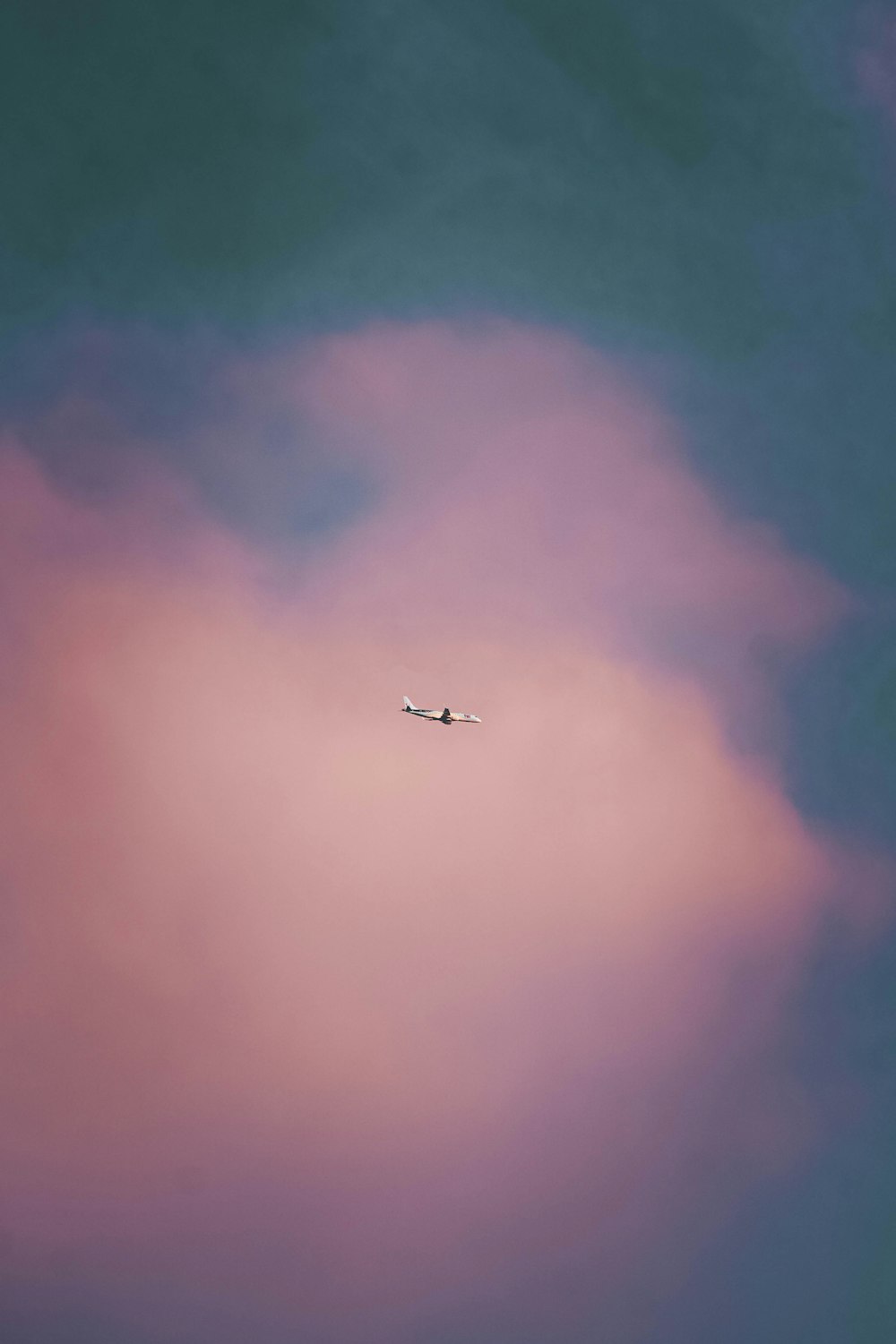 an airplane is flying through a cloudy sky