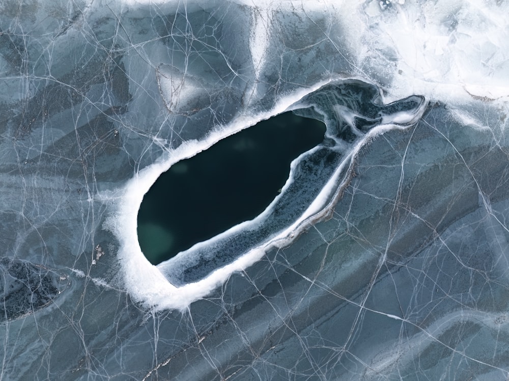 an aerial view of a lake surrounded by ice