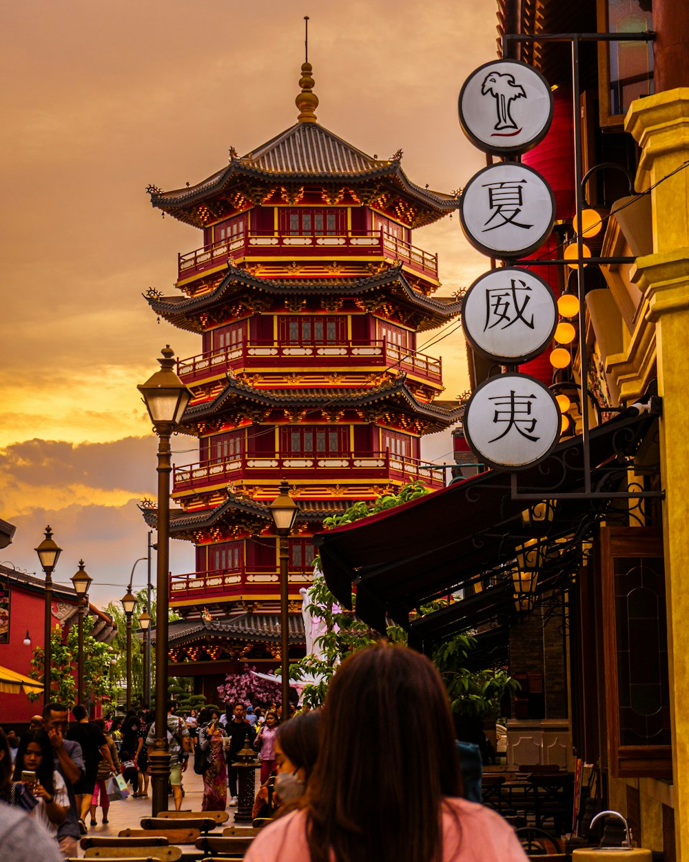 a woman standing in front of a tall building