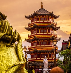 a tall building with a statue in front of it