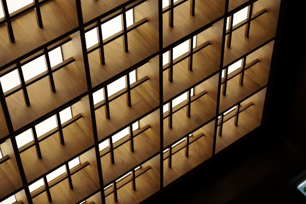 Custom steel shelving unit with geometric patterns against a dark wall