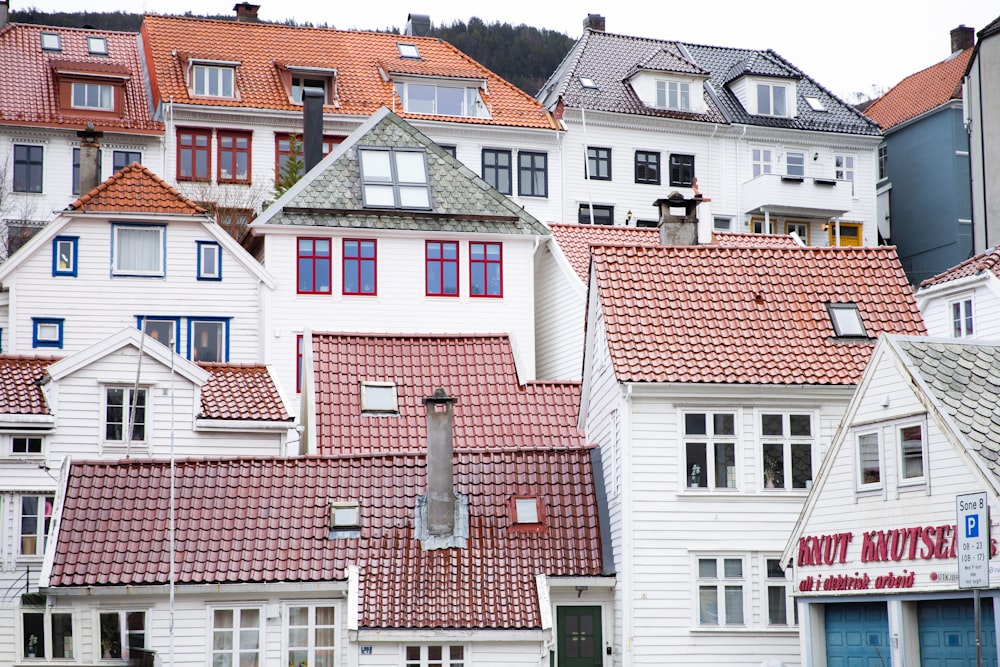 a row of white houses with red roofs