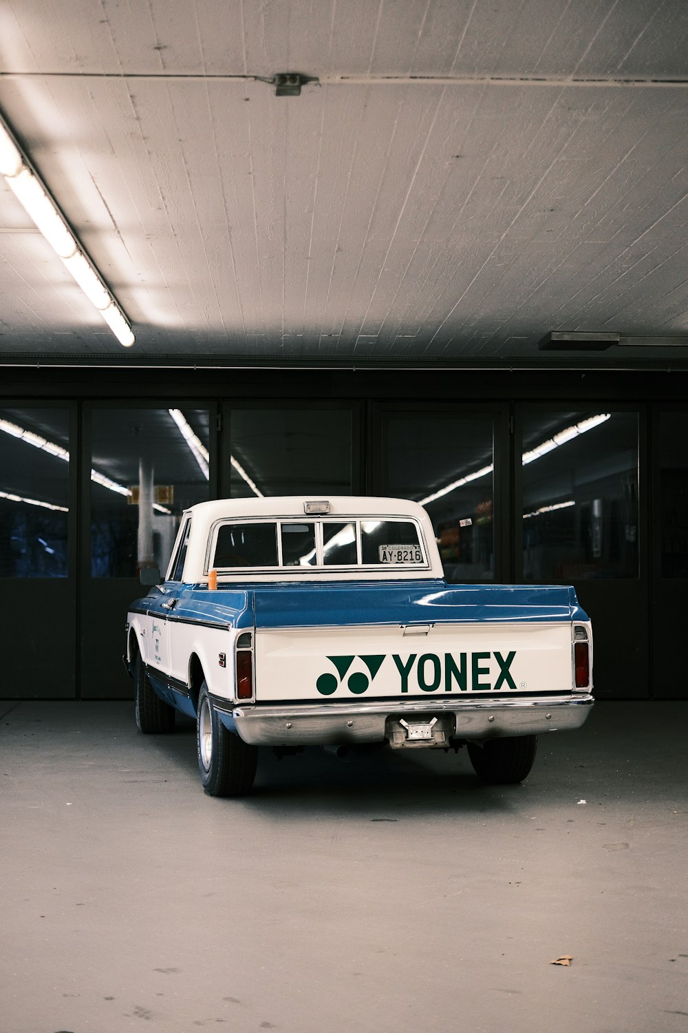 a blue and white truck parked in a garage
