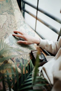 Close-up of hands holding vintage travel maps.