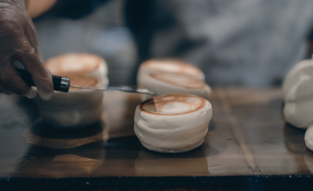 a person with a knife cutting into some food