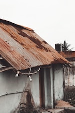 a run down house with a rusty roof