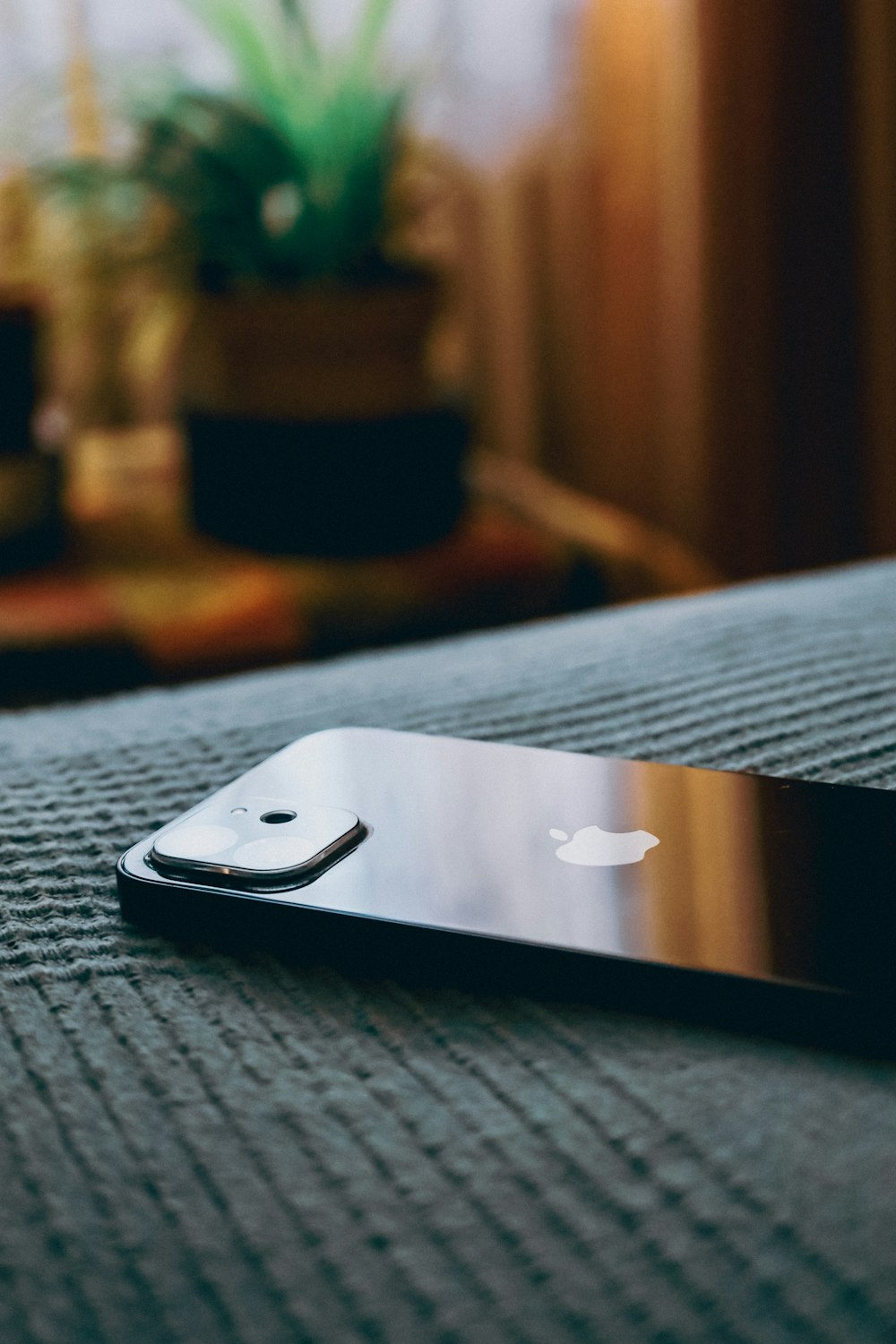 a close up of a cell phone on a bed