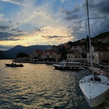 A serene Portuguese coastal village at sunset, with warm golden light reflecting on the water.