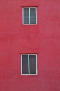 Bright white PVC window frame contrasting with a dark wall.