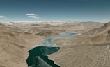 an aerial view of a river and mountains