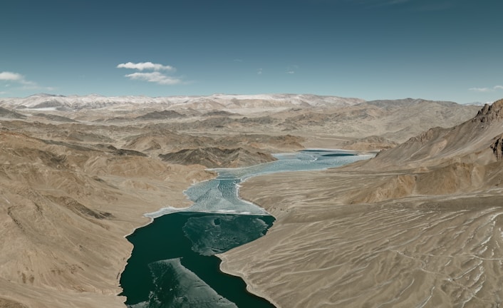 an aerial view of a river and mountains