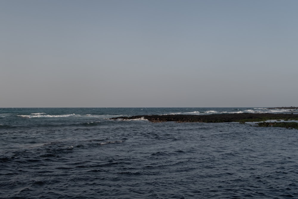 a large body of water with waves coming in to shore