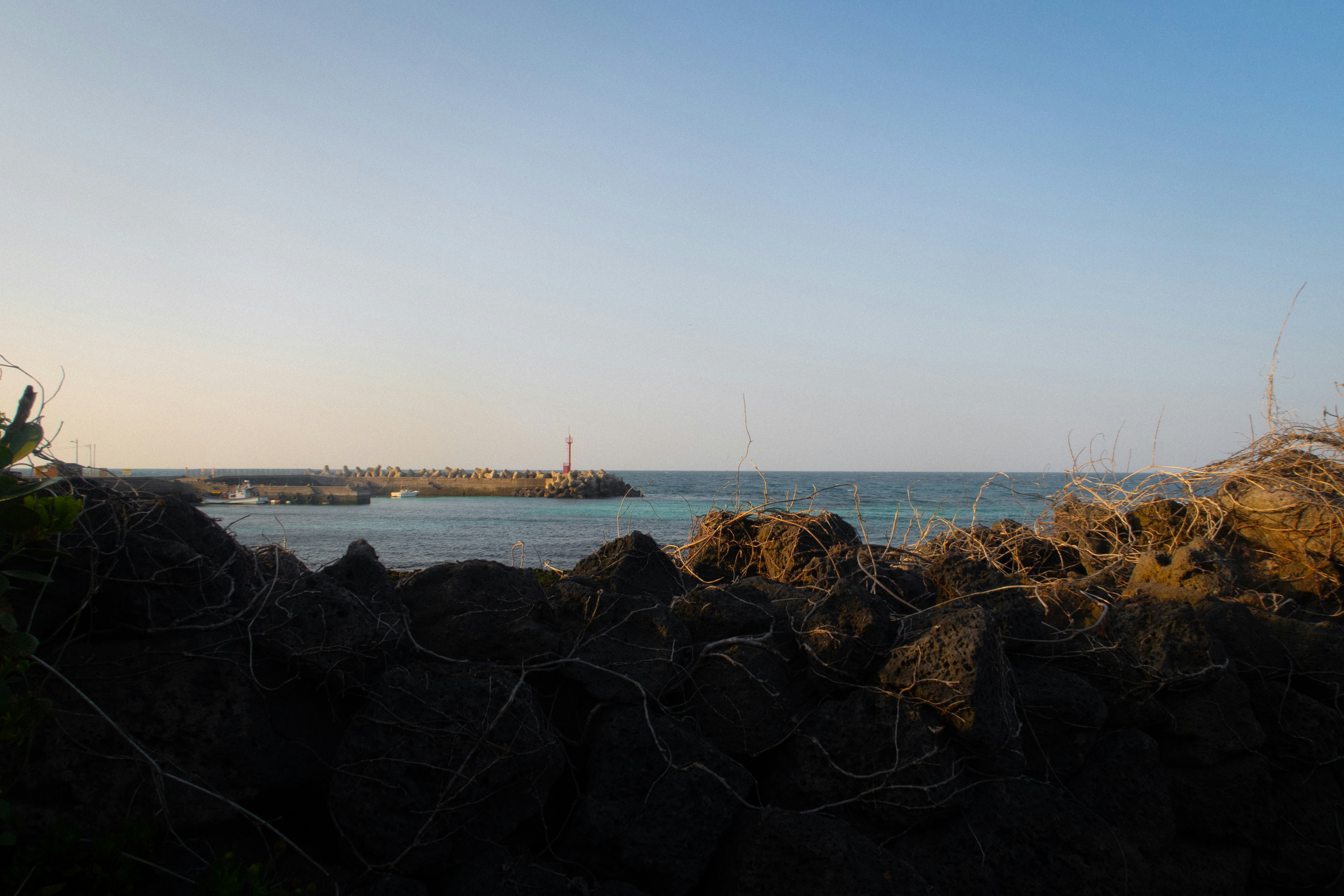 a view of the ocean from a rocky shore