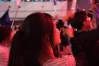 Happy people enjoying an event with pink decorations and luckybet banners