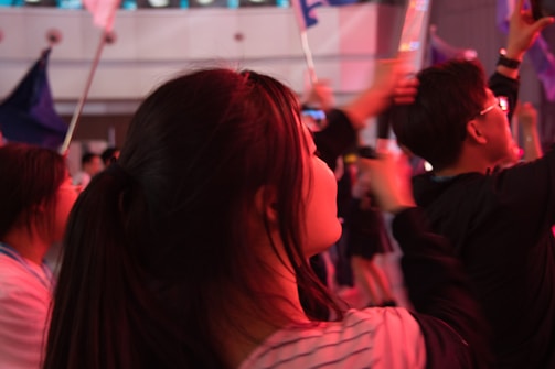 Happy people enjoying an event with pink decorations and luckybet banners