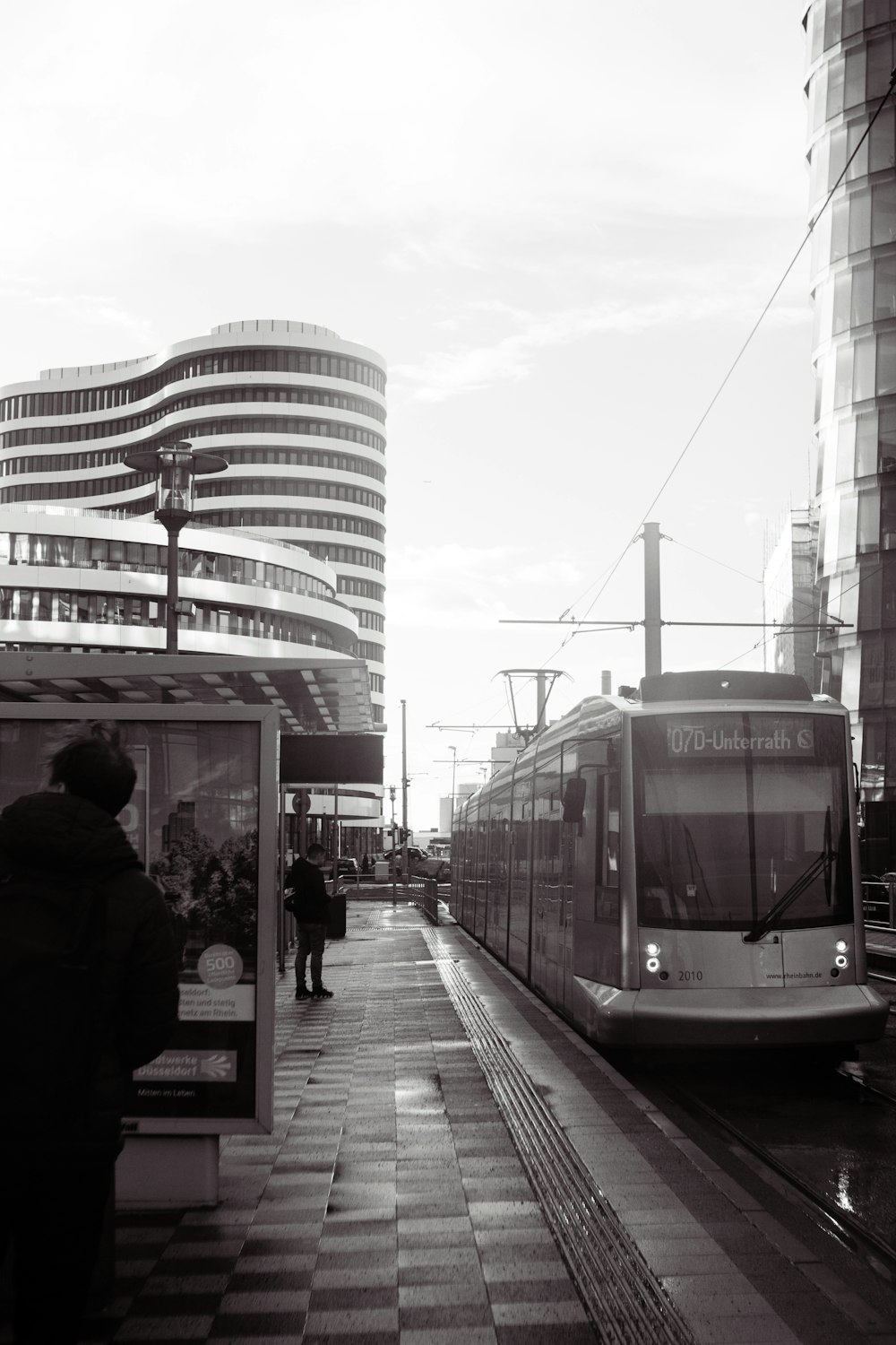 a black and white photo of a train at a train station