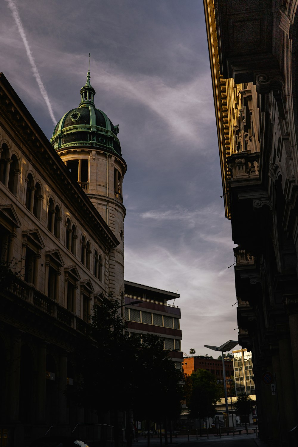 a tall building with a green dome on top